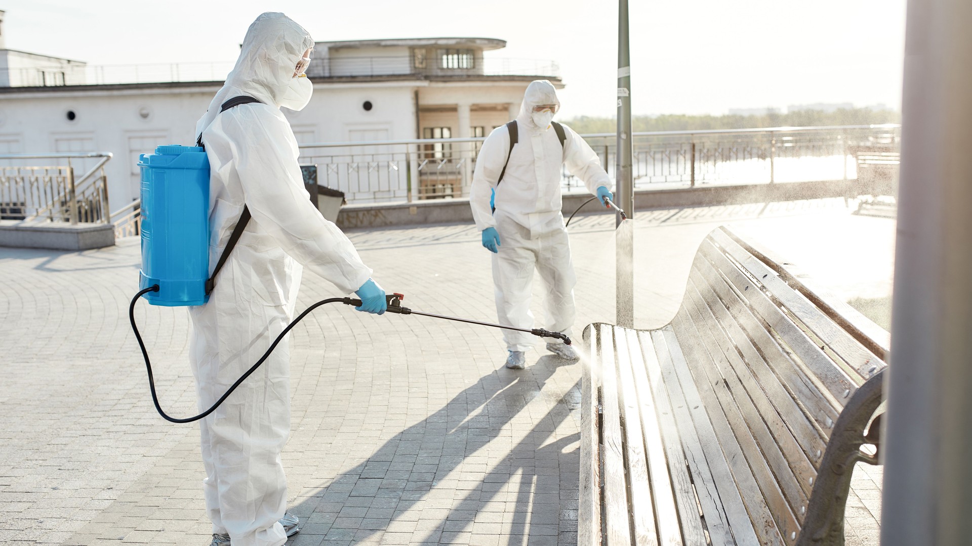 Extreme Clean. Sanitization, cleaning and disinfection of the city due to the emergence of the Covid19 virus. Specialized team in protective suits and masks at work